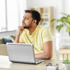 Man at computer deep in thought